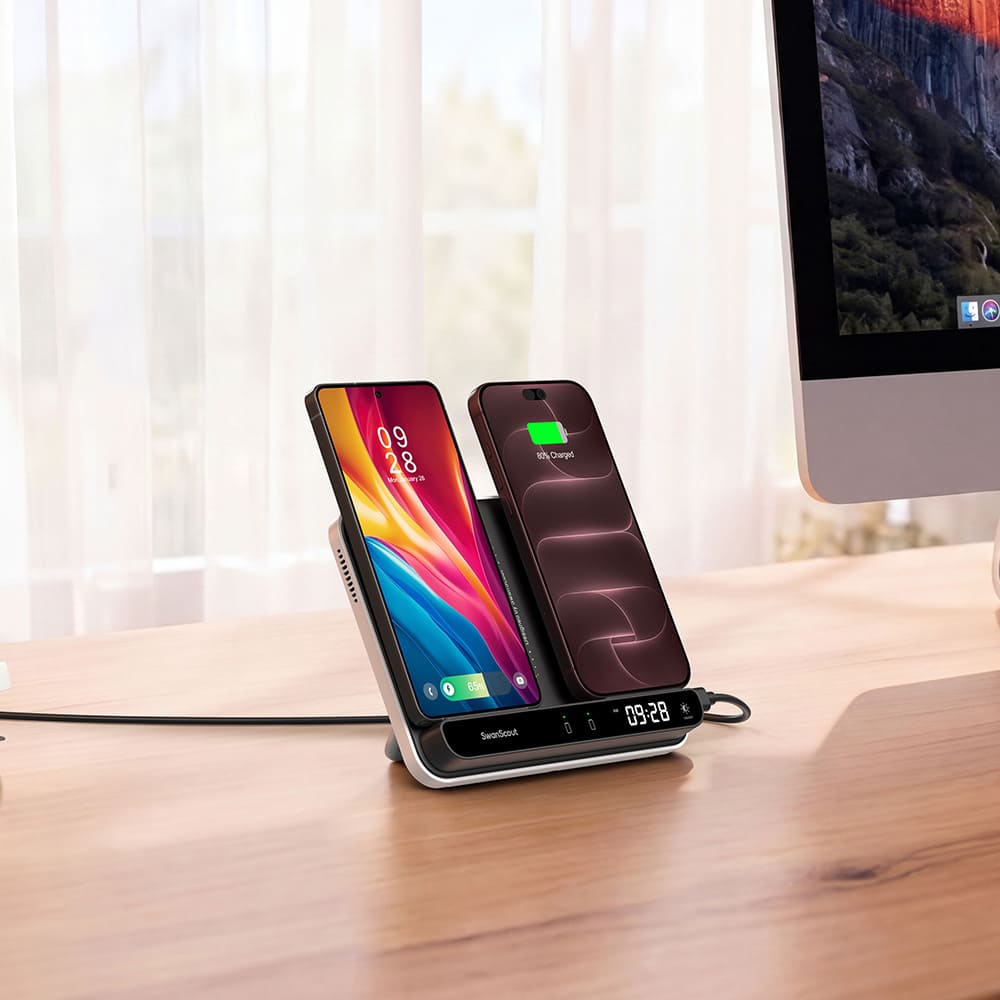 Dual phone wireless charging stand with LED clock on a work desk next to a monitor SwanScout 504
